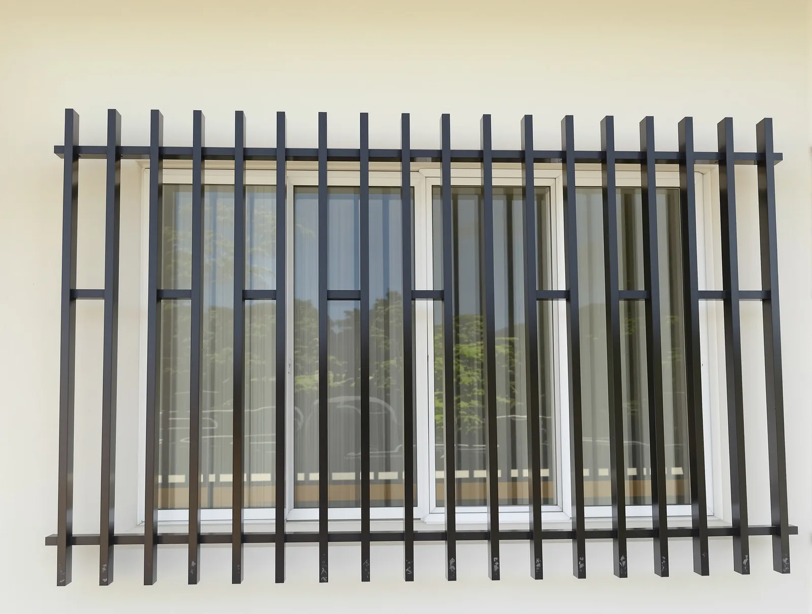 Modern window grill of black square bars with offset horizontal accents